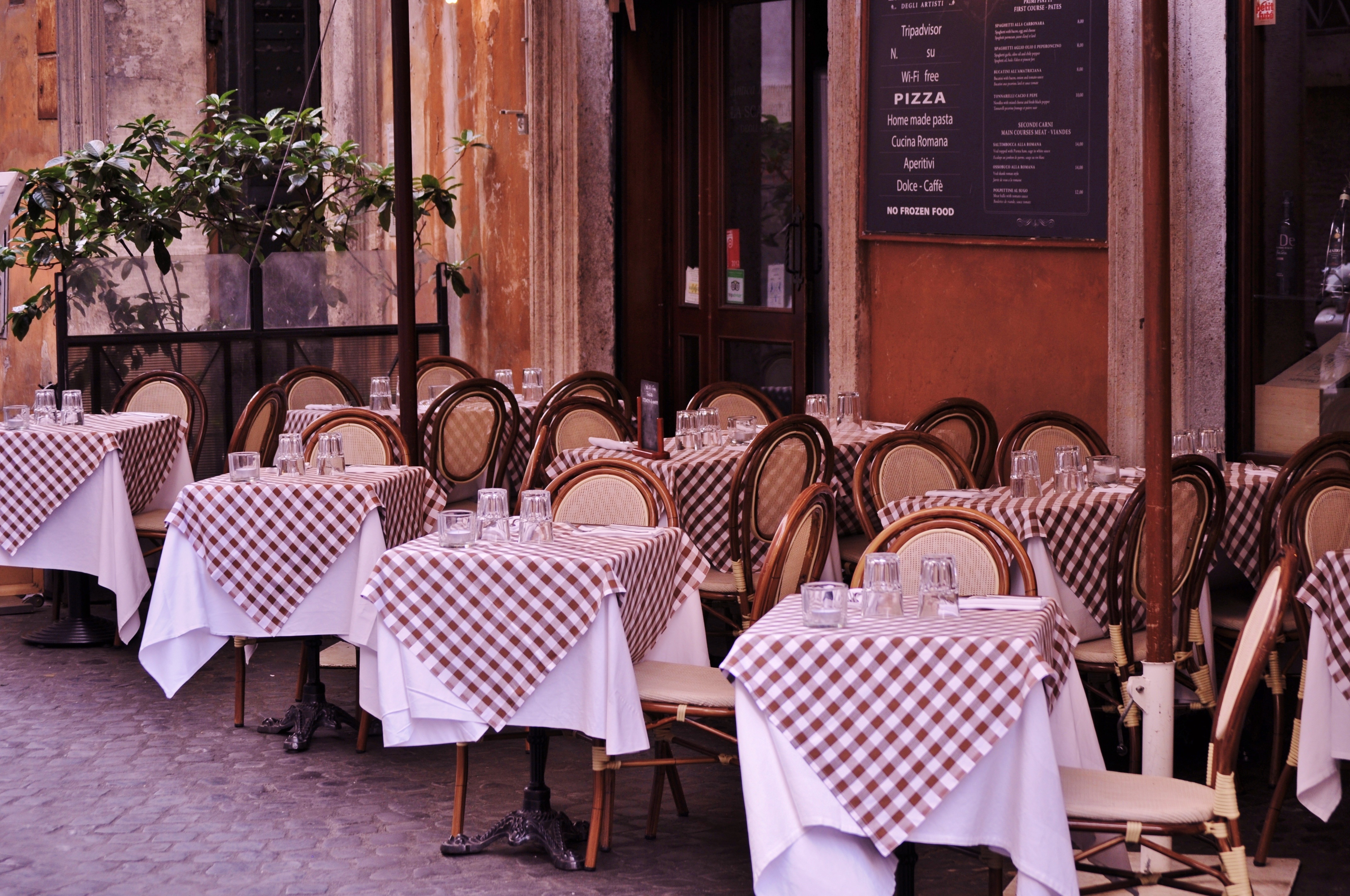 A classic Parisian bistro street scene with café tables and wicker chairs